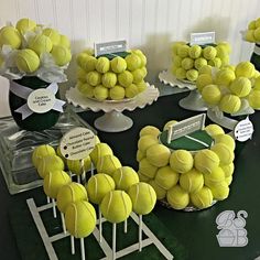 there are many tennis balls on the table and in vases with name tags attached to them