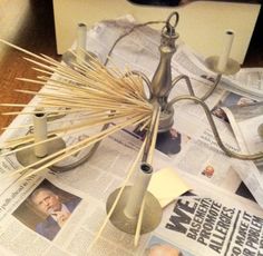 a lamp that is sitting on top of a news paper and some toothpicks