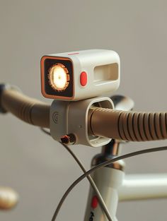 a close up of a bicycle with a light on it's handlebars