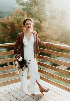 a woman standing on top of a wooden deck