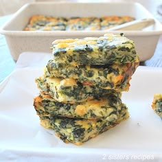 four pieces of food are stacked on top of each other in front of a baking dish