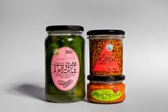 two jars filled with different types of food sitting next to each other on a white surface