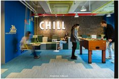 people playing games in an office setting with blue walls and flooring that says chill