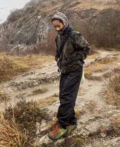 a man standing on top of a rocky hillside