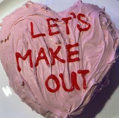 a heart shaped cake with the words let's make out written on it