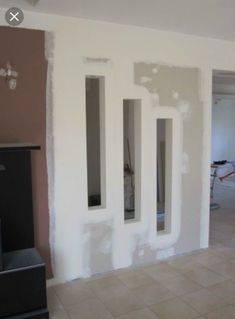 an empty room with white paint on the walls