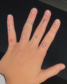 a person's hand with tattoos on it