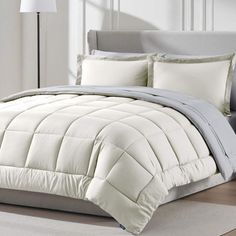 the comforter is white and grey in color