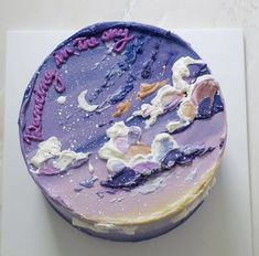 there is a cake with purple frosting and stars on it