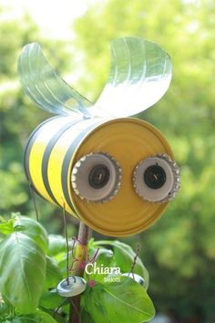 a close up of a plant with a toy bee on it's head and eyes