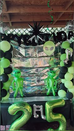 an alien themed birthday party with balloons and decorations