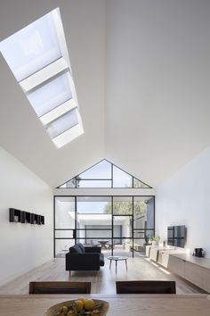 a living room filled with furniture and a skylight