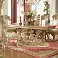 an ornate dining room table with chairs and chandelier