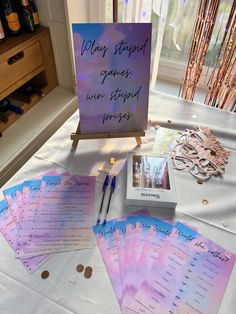 a table topped with lots of cards and pens