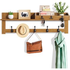 a coat rack with hats, purses and other items hanging on the wall above it