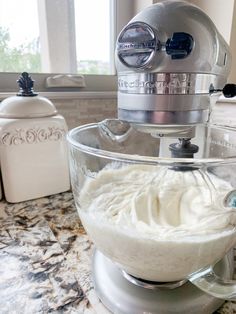 a kitchen mixer with whipped cream in it