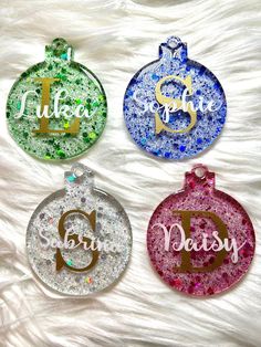 three personalized christmas ornament ornaments on a white furnishing with glitter