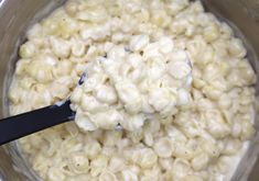 macaroni and cheese being stirred in a pot