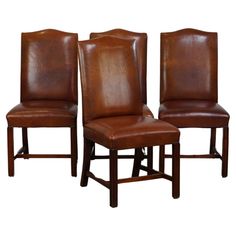 three brown leather chairs sitting side by side