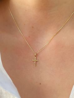 This unique dainty Crucifix Cross Necklace features a small gold cross with a high polish finish that sits on a delicate 14K Yellow Gold chain. It's perfect for layering with your favorites or styled solo for a classic look. Necklace Length: 16 Inches *with a 2-inch extension Pendant Length: 1.6 cm * Bail: 0.4 cm Pendant Width: 1 cm Chain Type: Flat Cable Clasp: Lobster Metal: 14K Yellow Gold (stamped) Small Gold Cross Necklace, Good Cross Necklace, Gold Jewelry Cross, Crucifix Necklace Women, Cross Necklace Aesthetic, Cross Gold Necklace, Orthodox Cross Necklace, Gold Crucifix Necklace, Jesus Cross Necklace