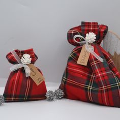 two red and black plaid bags sitting on top of a white table next to each other