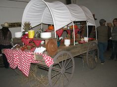 an old wagon is loaded with food and other things to eat for the party guests