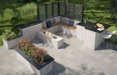 an aerial view of a patio with outdoor furniture and plants on the side, along with a fire pit in the middle