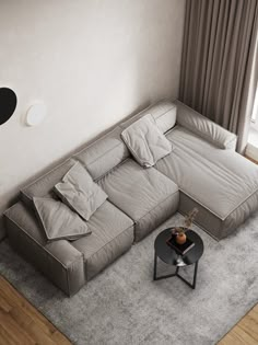 a living room with a sectional couch and coffee table