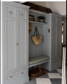 a room with some white cabinets and a basket on the door shelf next to it