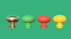 four different colored knobs on a green background