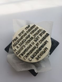 a cake that is sitting on top of a napkin with words written in black and white