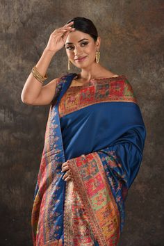 Exquisite blue Kani silk saree is one of a kind drape for a saree wardrobe! It comes with a matching blouse piece. Shop designer sarees in USA from Pure Elegance. Disclaimer: The shown stitched blouse on the model is for display purpose only. The saree comes with a matching blouse piece and finished with fall and piko. The actual product may vary slightly from the image. These are custom orders, hence expect slight variation in color, placement of the motif or buta. ESTIMATED DELIVERYBecause this is a custom order, it would take about 4 weeks from the date of purchase. RETURN POLICYThis product is a custom order and cannot be returned or exchanged. Blue Pre-draped Saree With Zari Weaving For Navratri, Blue Pre-draped Saree With Zari Work For Festivals, Traditional Blue Pre-draped Saree With Dupatta, Blue Jamawar Pre-draped Saree With Zari Weaving, Traditional Blue Pre-draped Saree With Self Design, Traditional Blue Pre-draped Saree For Festivals, Blue Bollywood Banarasi Silk Pre-draped Saree, Blue Raw Silk Pre-draped Saree For Festivals, Festive Blue Handloom Pre-draped Saree