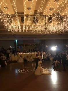 the bride and groom are dancing on the dance floor