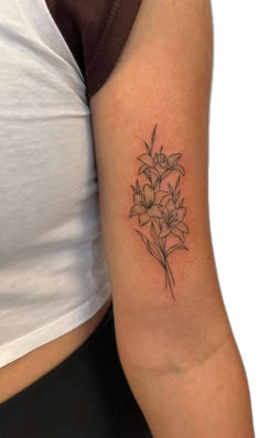 Lion Rose Clock Tattoo, Flower Tattoos Patchwork, Flower Tattoo Placement Ideas Arm, Leo Floral Tattoo, Lily Vine Tattoo Design, Rose And Holly Tattoo, Tiny Tractor Tattoo, Tattoo Ideas For Females Unique, Lilies Flower Tattoo