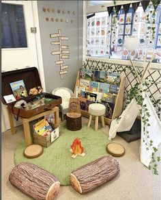 a room filled with lots of furniture and books on the floor next to a fire pit