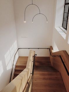 an overhead view of some stairs and railings in a room with light coming through the windows