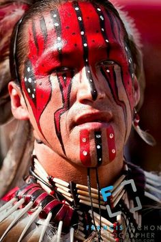 a native american man with red and black paint on his face