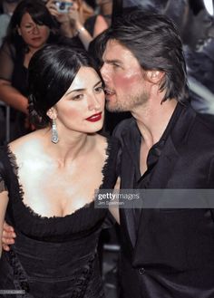 the couple is kissing on the red carpet at an event in front of a crowd