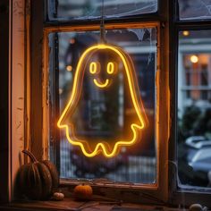 a neon ghost sitting on top of a window sill