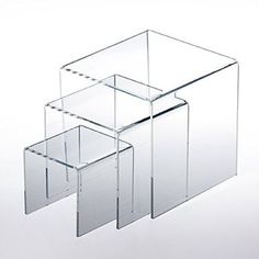 three clear boxes are stacked on top of each other in the shape of rectangles