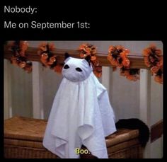 a white ghost stuffed animal sitting on top of a basket