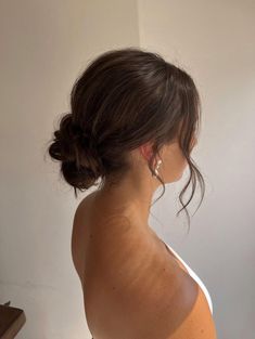 a woman with her hair in a low bun