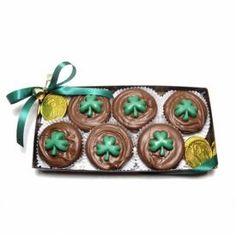 chocolate cupcakes decorated with shamrock leaves and gold coins in a decorative gift box