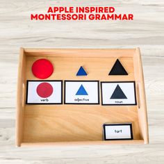 an apple inspired montessorigrammar is displayed in a wooden tray with four different shapes