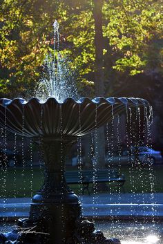 a fountain with water spouting from it's sides