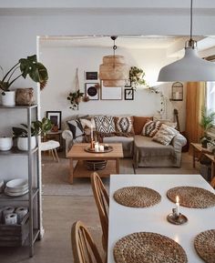 a living room filled with lots of furniture next to a dining table and couches