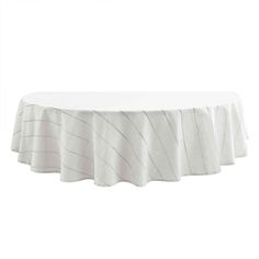 a white table cloth on top of a round table with an uneven design in the center