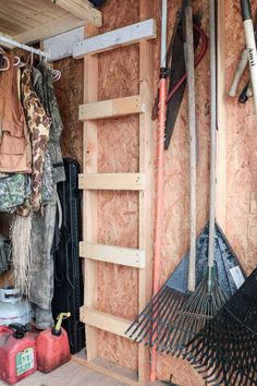 the inside of a storage shed with tools and other items hanging from it's walls