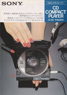 a woman's hands holding a compact disc player