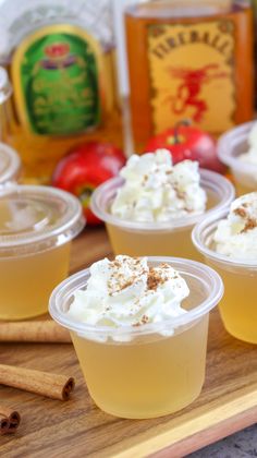 small cups with whipped cream and cinnamon on a cutting board